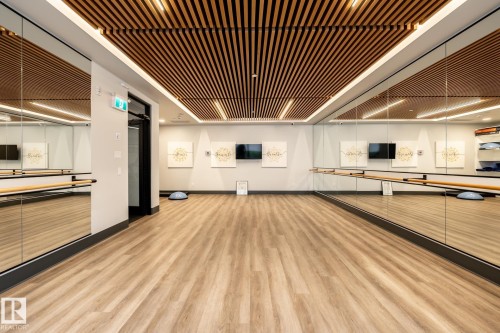 Workout area with baseboards and light wood finished floors - 7471 May Common, Edmonton, AB - Indoor Photo Showing Other Room