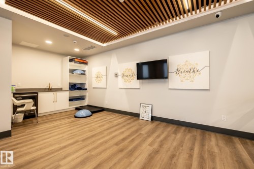 Exercise area with light wood finished floors and recessed lighting - 7471 May Common, Edmonton, AB - Indoor Photo Showing Other Room