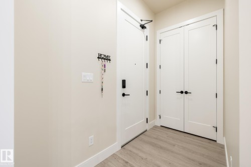 Entryway with wood finished floors and baseboards - 7471 May Common, Edmonton, AB - Indoor Photo Showing Other Room
