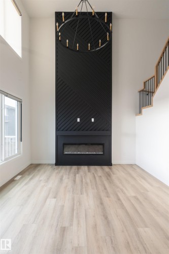 Unfurnished living room with plenty of natural light, light wood-type flooring, and a high ceiling - 163 Starling Way, Fort Saskatchewan, AB - Indoor