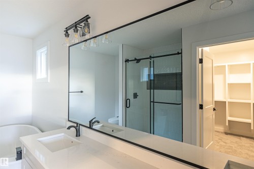Full bathroom with a shower stall, vanity, a soaking tub, and a spacious closet - 163 Starling Way, Fort Saskatchewan, AB - Indoor Photo Showing Bathroom