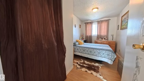 Bedroom featuring a textured ceiling and light wood-type flooring - 3122 142 Avenue, Edmonton, AB - Indoor Photo Showing Bedroom