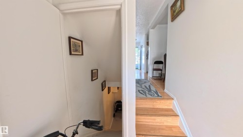 Stairway featuring wood finished floors and baseboards - 3122 142 Avenue, Edmonton, AB - Indoor Photo Showing Other Room