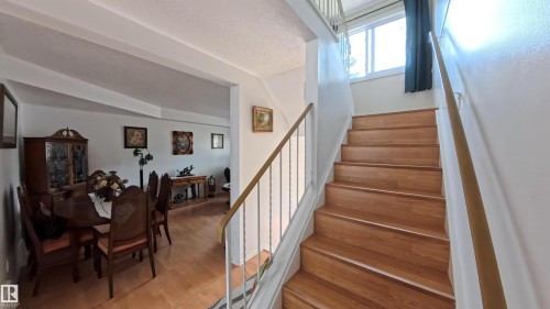 Stairway with wood finished floors and a textured ceiling - 3122 142 Avenue, Edmonton, AB - Indoor Photo Showing Other Room