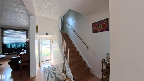 Stairway with a textured ceiling - 3122 142 Avenue, Edmonton, AB - Indoor Photo Showing Other Room