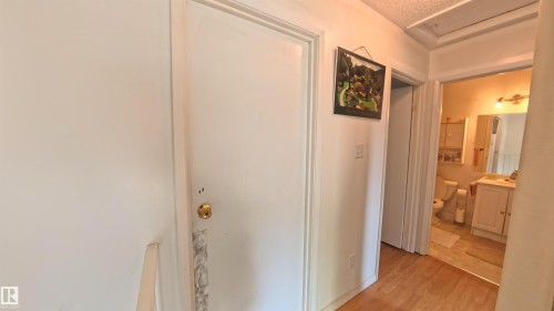 Corridor featuring light wood-style floors and attic access - 3122 142 Avenue, Edmonton, AB - Indoor Photo Showing Other Room