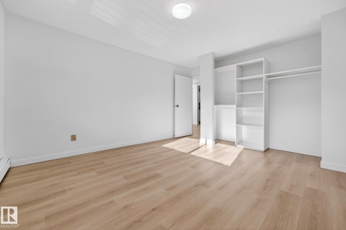 Unfurnished bedroom with light wood-style floors and a closet - 207 11007 83 Avenue, Edmonton, AB - Indoor Photo Showing Other Room