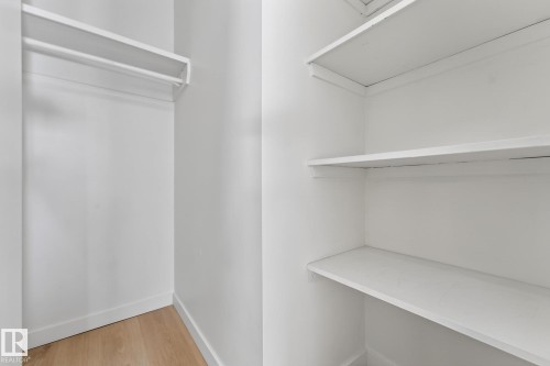 Walk in closet featuring light wood-style floors - 207 11007 83 Avenue, Edmonton, AB - Indoor With Storage