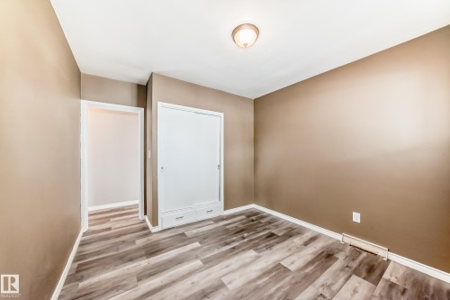 Unfurnished bedroom with light wood finished floors and a closet - 8639 64 Avenue Nw, Edmonton, AB - Indoor Photo Showing Other Room