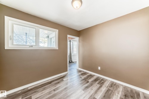 Empty room with light wood finished floors and baseboards - 8639 64 Avenue Nw, Edmonton, AB - Indoor Photo Showing Other Room