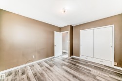 Unfurnished bedroom featuring wood finished floors and a closet - 