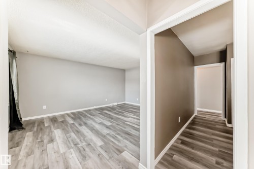 Hallway featuring wood finished floors - 8639 64 Avenue Nw, Edmonton, AB - Indoor Photo Showing Other Room