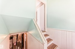 Staircase featuring a wainscoted wall and heating unit - 