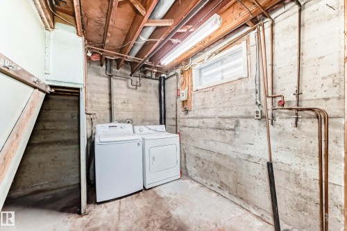 Unfinished basement featuring washing machine and clothes dryer - 8639 64 Avenue Nw, Edmonton, AB - Indoor Photo Showing Laundry Room