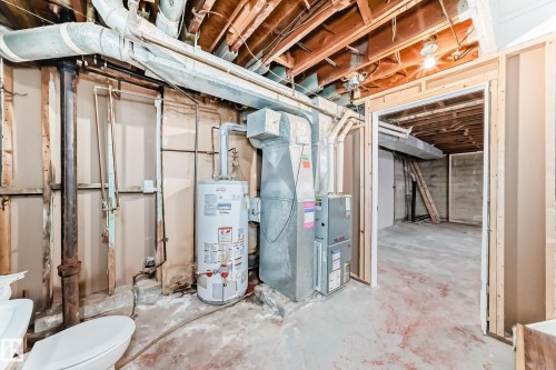 Unfinished below grade area with water heater and heating unit - 8639 64 Avenue Nw, Edmonton, AB - Indoor Photo Showing Basement