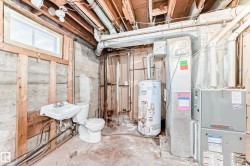 Basement featuring water heater and heating unit - 
