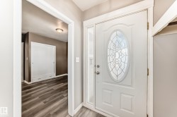 Foyer featuring wood finished floors and baseboards - 