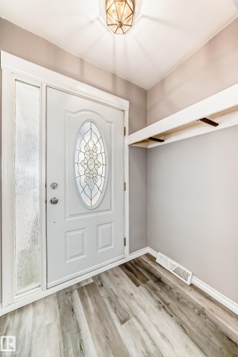 Entryway featuring light wood finished floors and baseboards - 8639 64 Avenue Nw, Edmonton, AB - Indoor Photo Showing Other Room