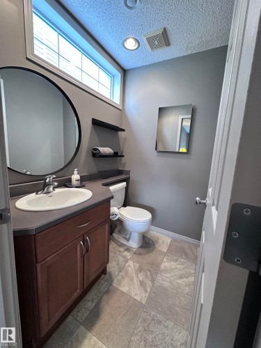 Bathroom with vanity and a textured ceiling - 23 4821 Terwillegar Common, Edmonton, AB - Indoor Photo Showing Bathroom