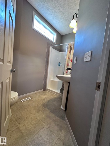 Full bathroom with a stall shower and a textured ceiling - 23 4821 Terwillegar Common, Edmonton, AB - Indoor Photo Showing Bathroom