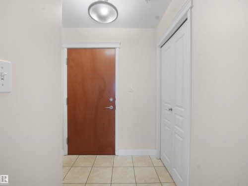 Hallway featuring baseboards and light tile patterned floors - 308 10333 112 Street Street, Edmonton, AB - Indoor Photo Showing Other Room