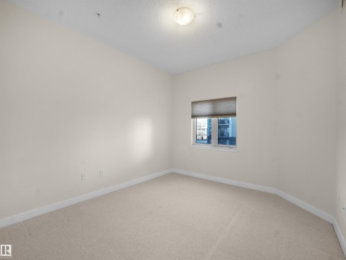 Empty room featuring carpet floors and a textured ceiling - 308 10333 112 Street Street, Edmonton, AB - Indoor Photo Showing Other Room