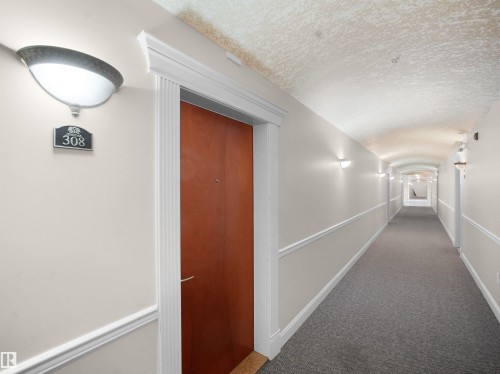 Hallway with carpet flooring and baseboards - 308 10333 112 Street Street, Edmonton, AB - Indoor Photo Showing Other Room