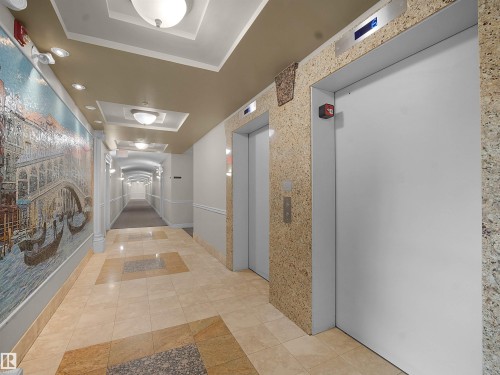 Corridor with elevator, a raised ceiling, tile patterned floors, and recessed lighting - 308 10333 112 Street Street, Edmonton, AB - Indoor Photo Showing Other Room