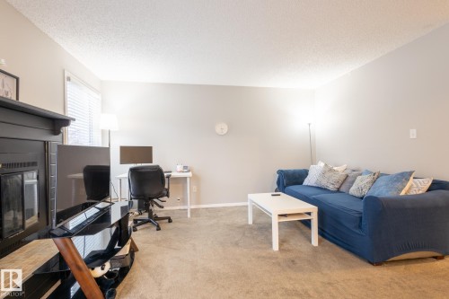 Carpeted office with a textured ceiling and baseboards - 3530 42 Street, Edmonton, AB - Indoor With Fireplace