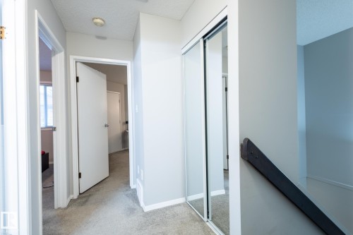 Corridor with light colored carpet and a textured ceiling - 3530 42 Street, Edmonton, AB - Indoor Photo Showing Other Room