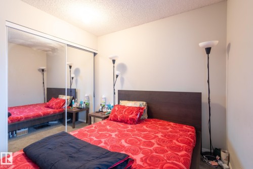 Bedroom featuring carpet floors, a textured ceiling, and a closet - 3530 42 Street, Edmonton, AB - Indoor Photo Showing Bedroom