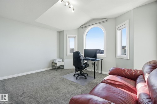 Carpeted office space with lofted ceiling and baseboards - 48 Douglas Crescent, Leduc, AB - Indoor