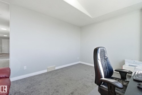 Home office with carpet flooring and baseboards - 48 Douglas Crescent, Leduc, AB - Indoor Photo Showing Office