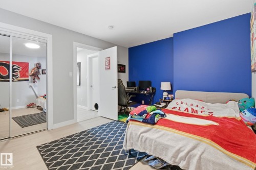 Bedroom featuring light wood-style flooring, a closet, and an office area - 48 Douglas Crescent, Leduc, AB - Indoor Photo Showing Bedroom