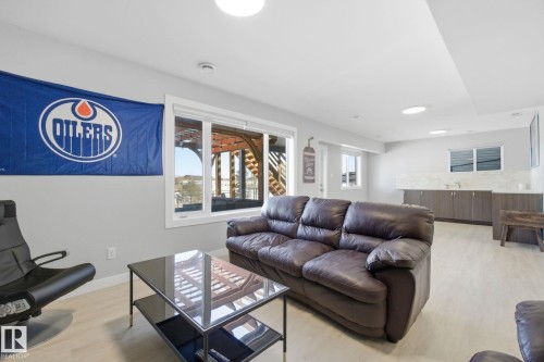 Living room with light wood-style flooring and baseboards - 48 Douglas Crescent, Leduc, AB - Indoor Photo Showing Living Room