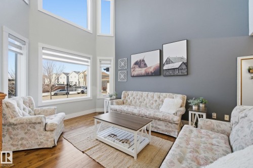Living area featuring wood-type flooring and a high ceiling - 48 Douglas Crescent, Leduc, AB - Indoor Photo Showing Living Room