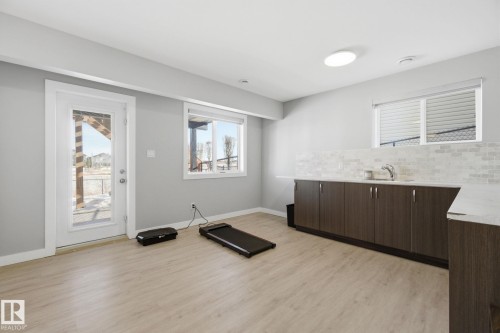 Exercise area with light wood-style floors and baseboards - 48 Douglas Crescent, Leduc, AB - Indoor Photo Showing Gym Room