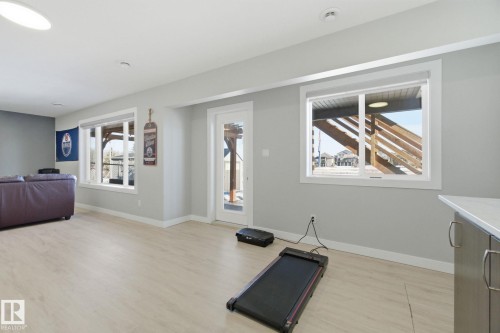 Exercise area featuring baseboards and light wood-style floors - 48 Douglas Crescent, Leduc, AB - Indoor