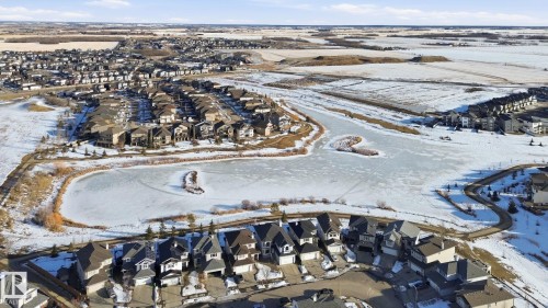 Snowy aerial view featuring a residential view - 48 Douglas Crescent, Leduc, AB - Outdoor With View