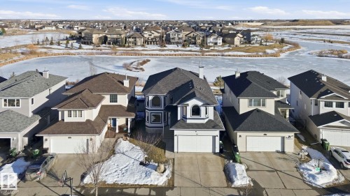 Snowy aerial view with a residential view - 48 Douglas Crescent, Leduc, AB - Outdoor With Facade