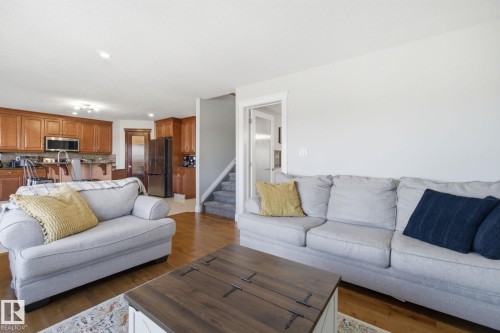 Living room with dark wood-style floors and recessed lighting - 48 Douglas Crescent, Leduc, AB - Indoor Photo Showing Living Room