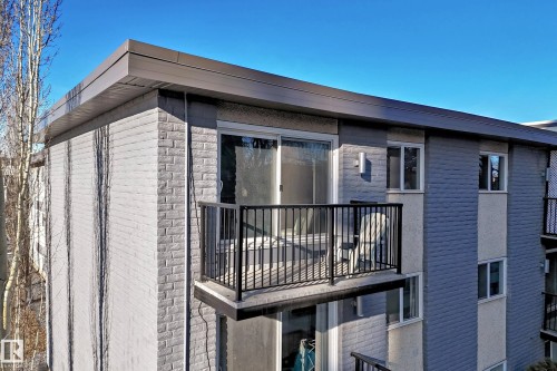 View of property exterior featuring a balcony and stone siding - 302 10606 123 Street, Edmonton, AB - Outdoor With Balcony
