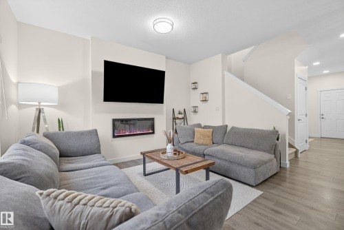 100 Meadowlink Common, Spruce Grove, AB - Indoor Photo Showing Living Room With Fireplace