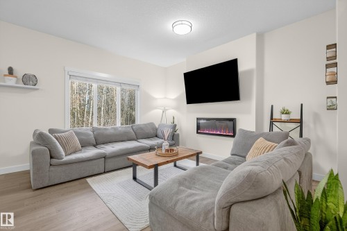 100 Meadowlink Common, Spruce Grove, AB - Indoor Photo Showing Living Room With Fireplace