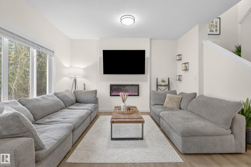 100 Meadowlink Common, Spruce Grove, AB - Indoor Photo Showing Living Room With Fireplace