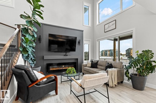 Living room featuring an electric fireplace and 18' ceiling. - 5 Starling, Fort Saskatchewan, AB 