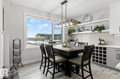 Dining area with serving bar, open shelving, wine/beverage cooler and built in wine rack. - 5 Starling, Fort Saskatchewan, AB 