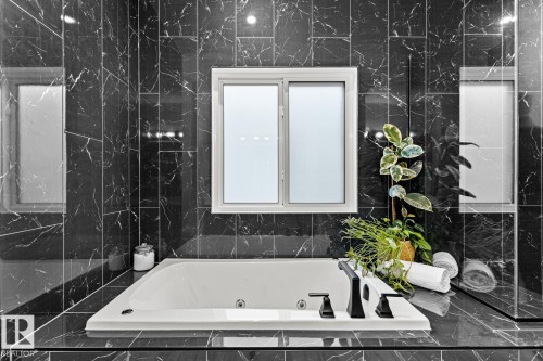 Full bathroom with a whirlpool tub and tile walls - 5 Starling, Fort Saskatchewan, AB 