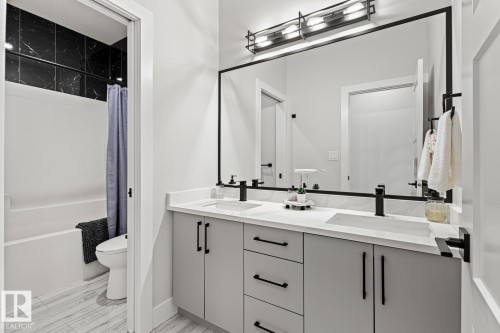 Main bathroom with dual sinks and 2nd room separated for privacy with toilet, tub/shower. - 5 Starling, Fort Saskatchewan, AB 