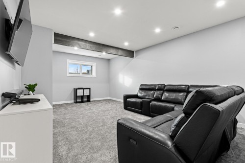 Spacious basement rec room with large window, carpet, recessed lighting and wood beam feature. - 5 Starling, Fort Saskatchewan, AB 